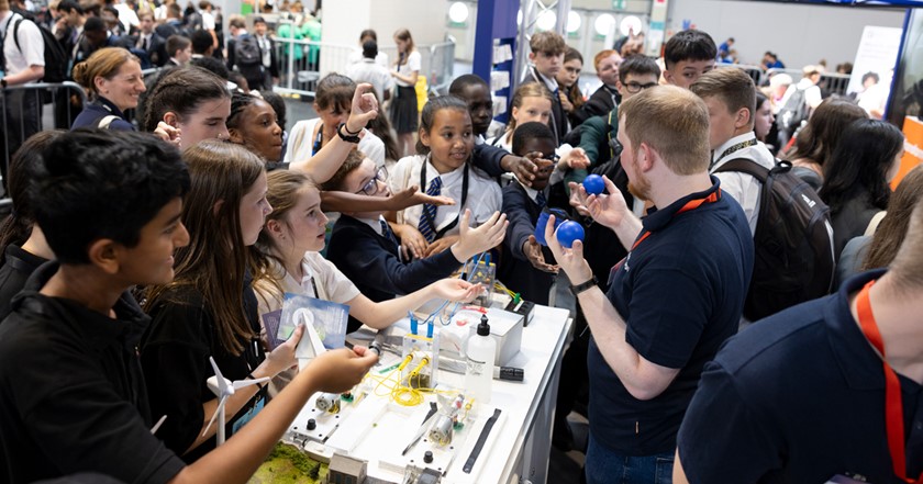 Young people excited and engaged at a stand on the showfloor of The Big Bang Fair