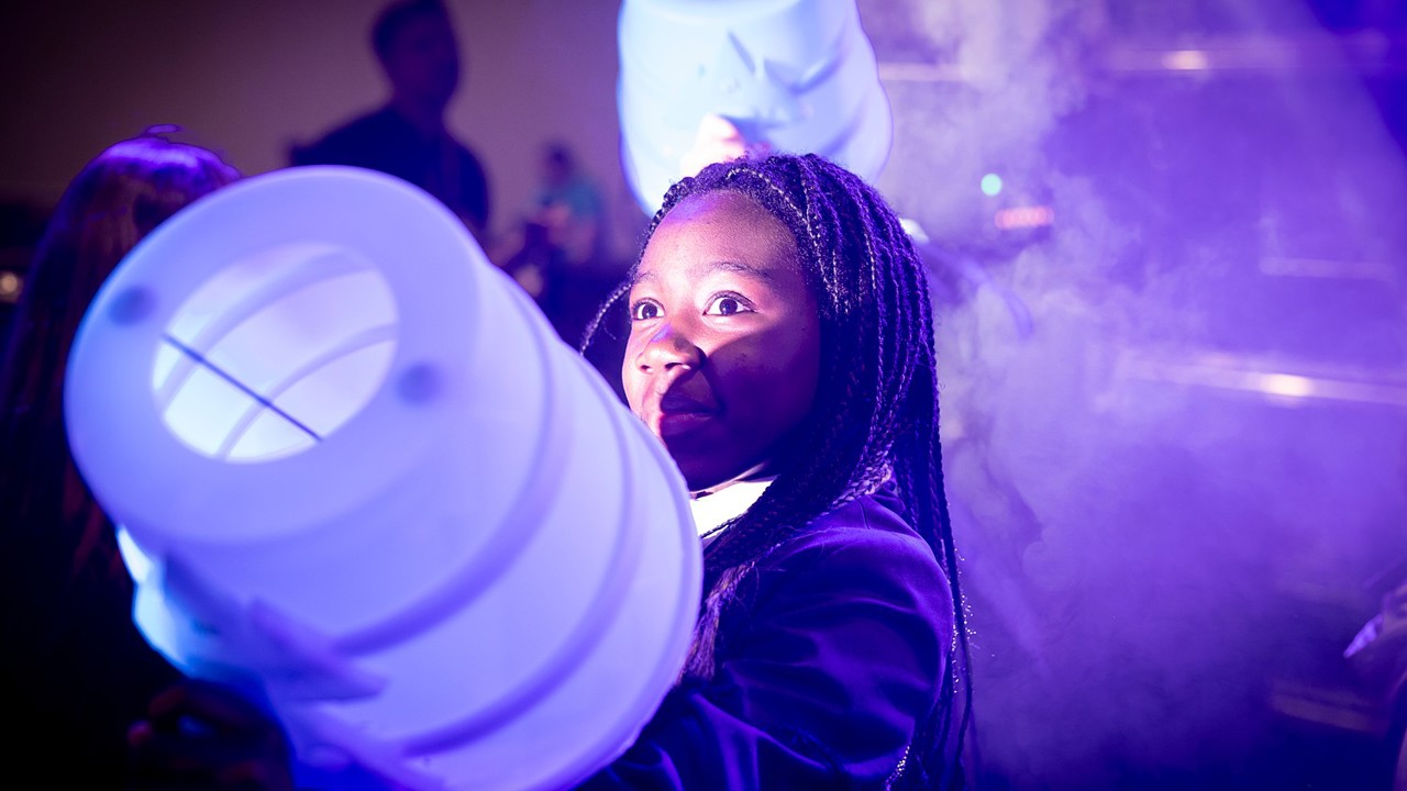 A young person interacts with exhibits and stands and activities at The Big Bang Fair