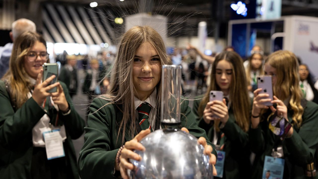 Young person discovers static energy with Van De Graaf Generator at The Big Bang Fair 