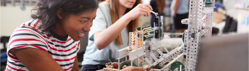 young multicultural female engineers engaged with meccano