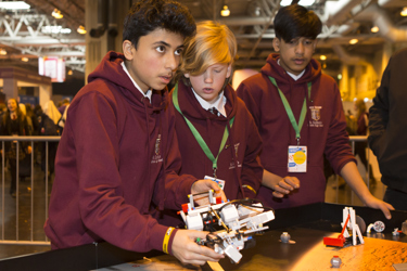 Young people interact with exhibits and stands and activities at The Big Bang Fair