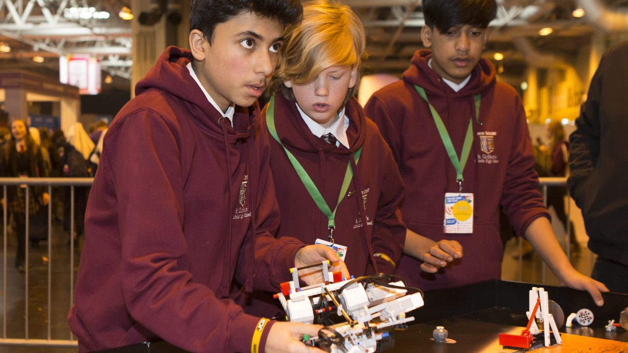 Young people interact with exhibits and stands and activities at The Big Bang Fair