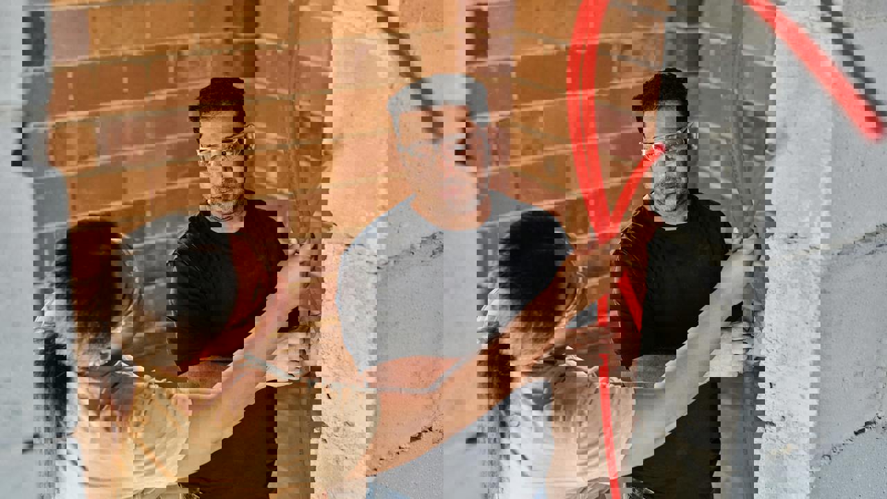 Two engineers working at a building site studying the construction materials