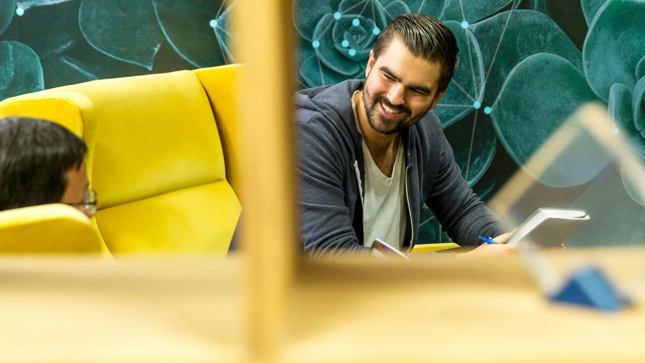 Business professional smiling and talking in a meeting