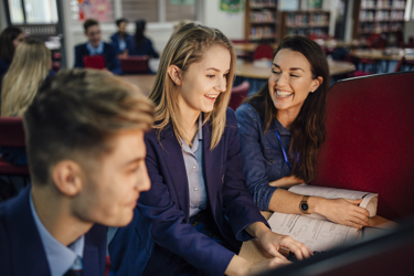 Secondary school girl working with teacher