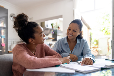 Young person working at home with an adult