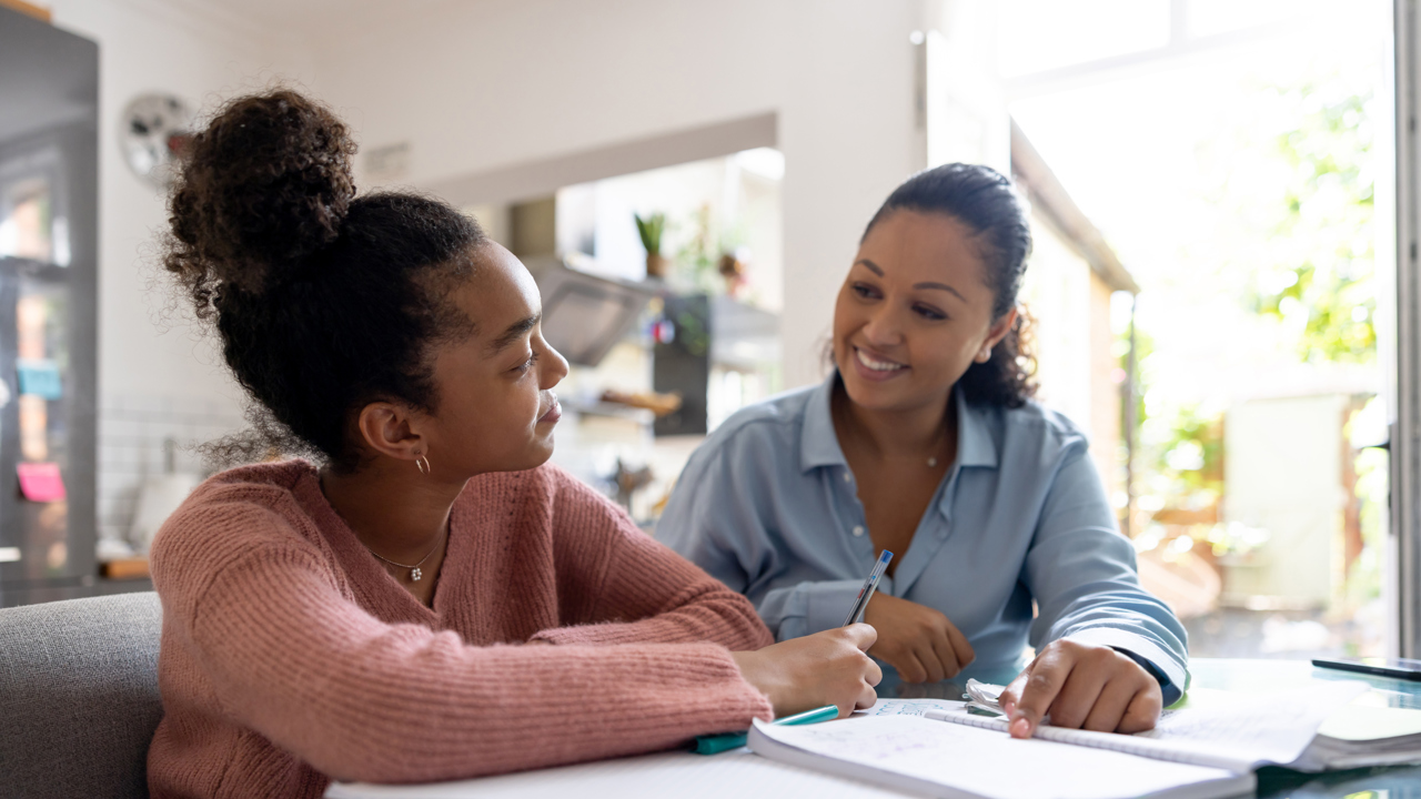 Young person working at home with an adult