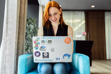 Person sitting on a comfy chair working on their laptop