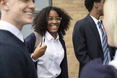 A group of young people talking outside school