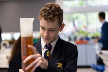 Young person in school science lab conducting an experiment