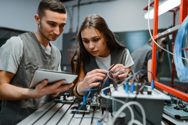 Two engineers work with cables and equipment