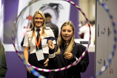 A pilot watches as student attempts to fly paper plane through obstacle course at The Big Bang Fair