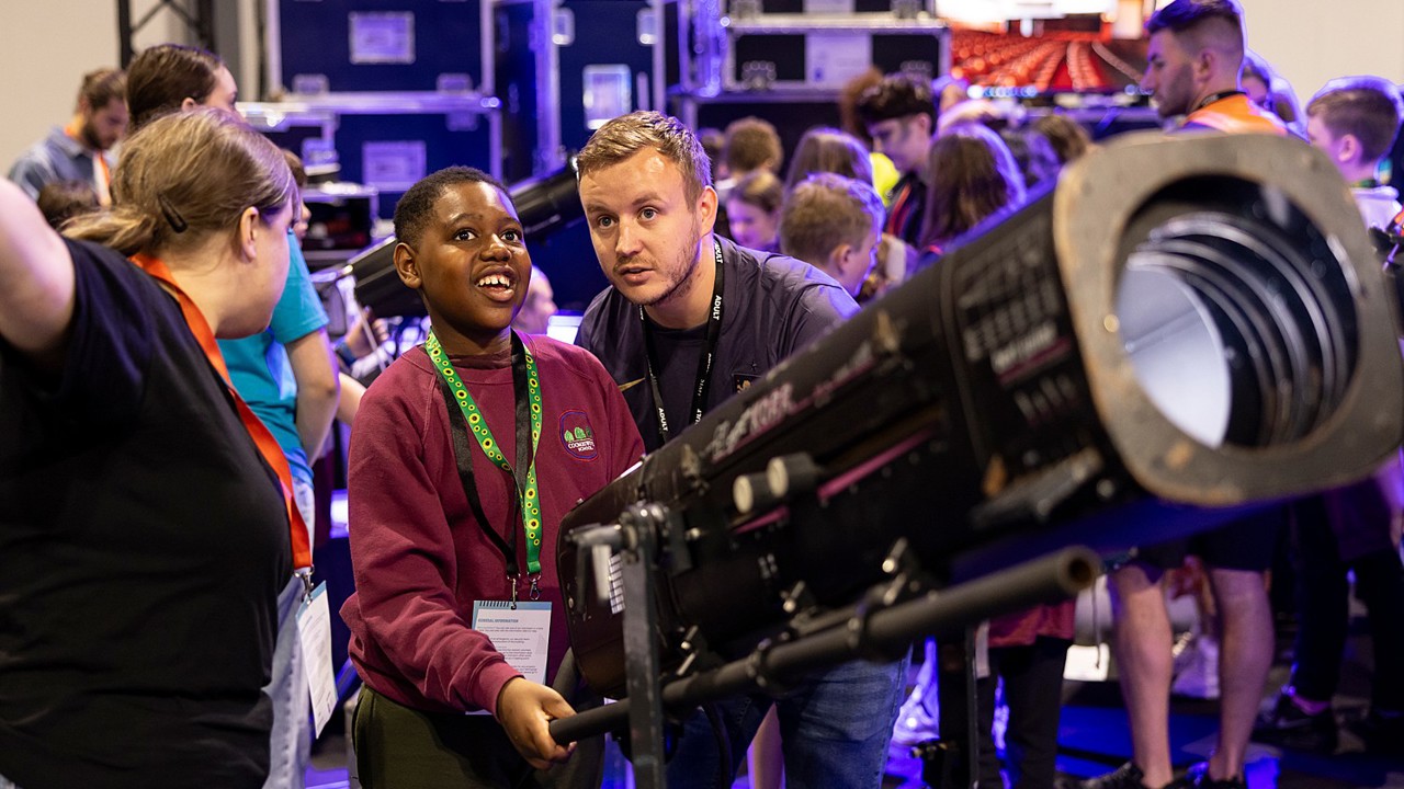 A young person interacts with exhibits and stands and activities at The Big Bang Fair