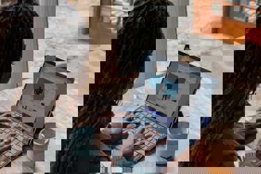 Women typing on a laptop