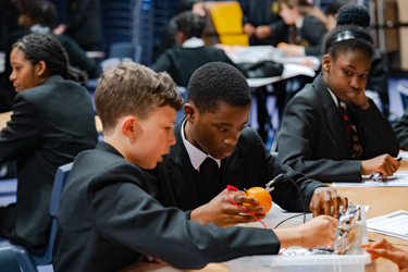 Two boys doing a fruit battery as part of the Energy Quest programme