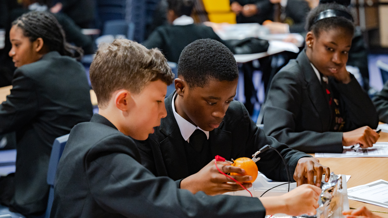 Two boys doing a fruit battery as part of the Energy Quest programme