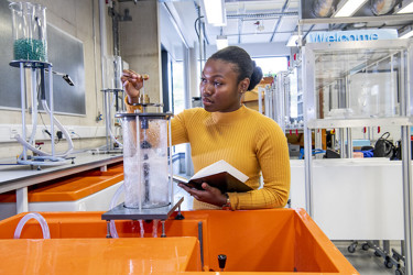 Person working with equipment and note book