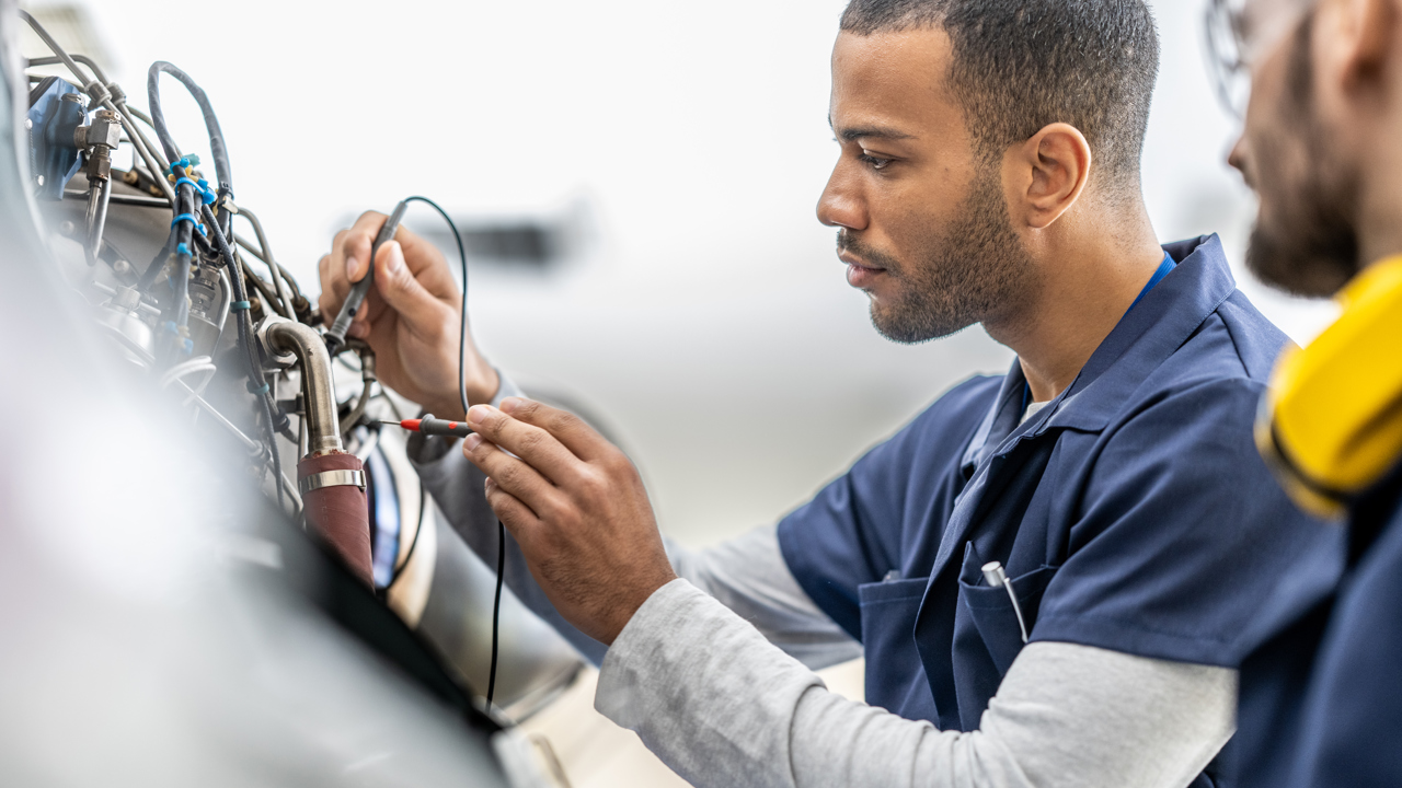 Two engineers work with cables