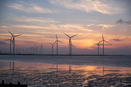 Wind turbines in water at sunset