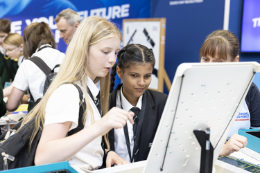 Two young people look at an exhibit