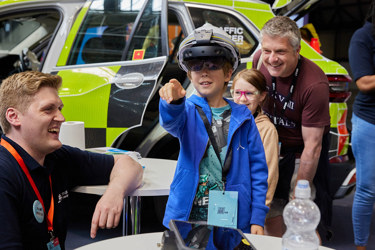 Young people interact with exhibits and stands and activities at The Big Bang Fair