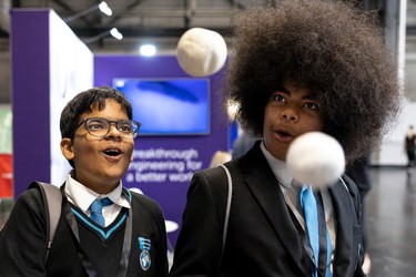 Young people interact with exhibits and stands and activities at The Big Bang Fair