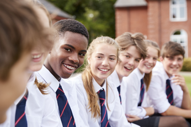 A group of young people at secondary school smiling and talking