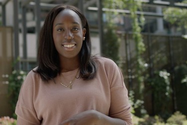 A person looking into camera as they smile 