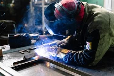 An engineer in protective clothing welding