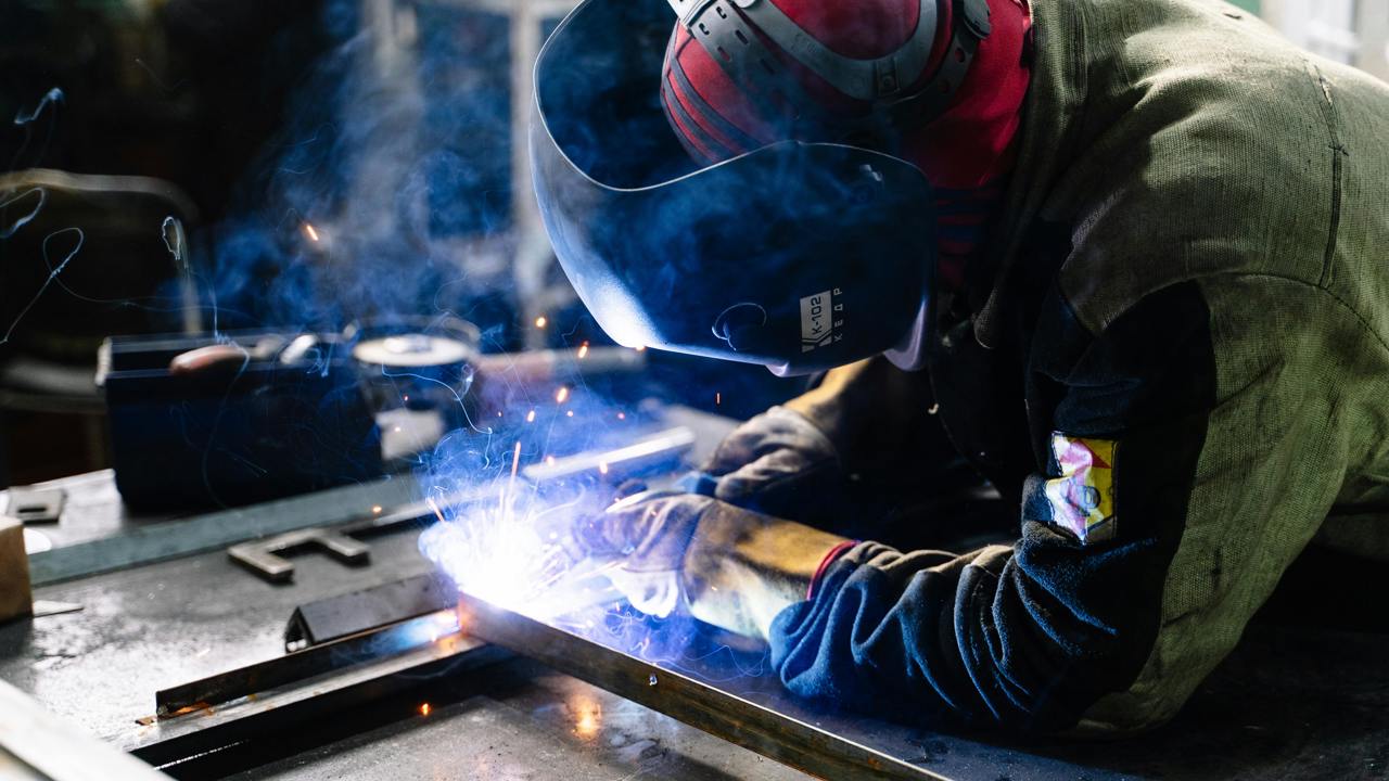 An engineer in protective clothing welding