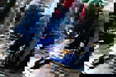 An engineer in protective clothing welding