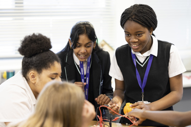 A group of girls doing the Energy Quest fruit experiment