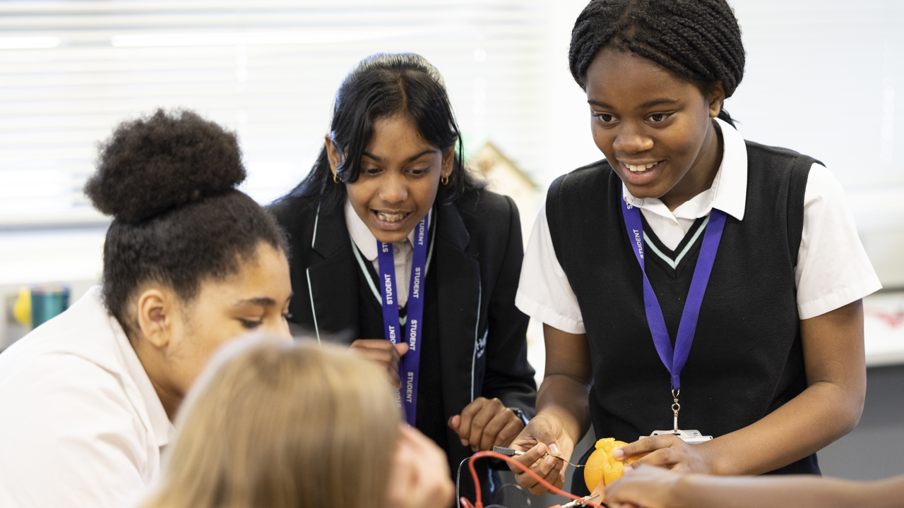 A group of girls doing the Energy Quest fruit experiment